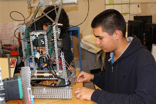 A student working on a machine/robot